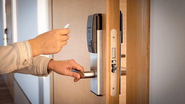 person with keycard opening door
