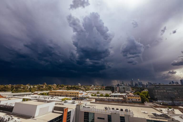 An intense summer weather system passes over commercial buildings in an industrial district