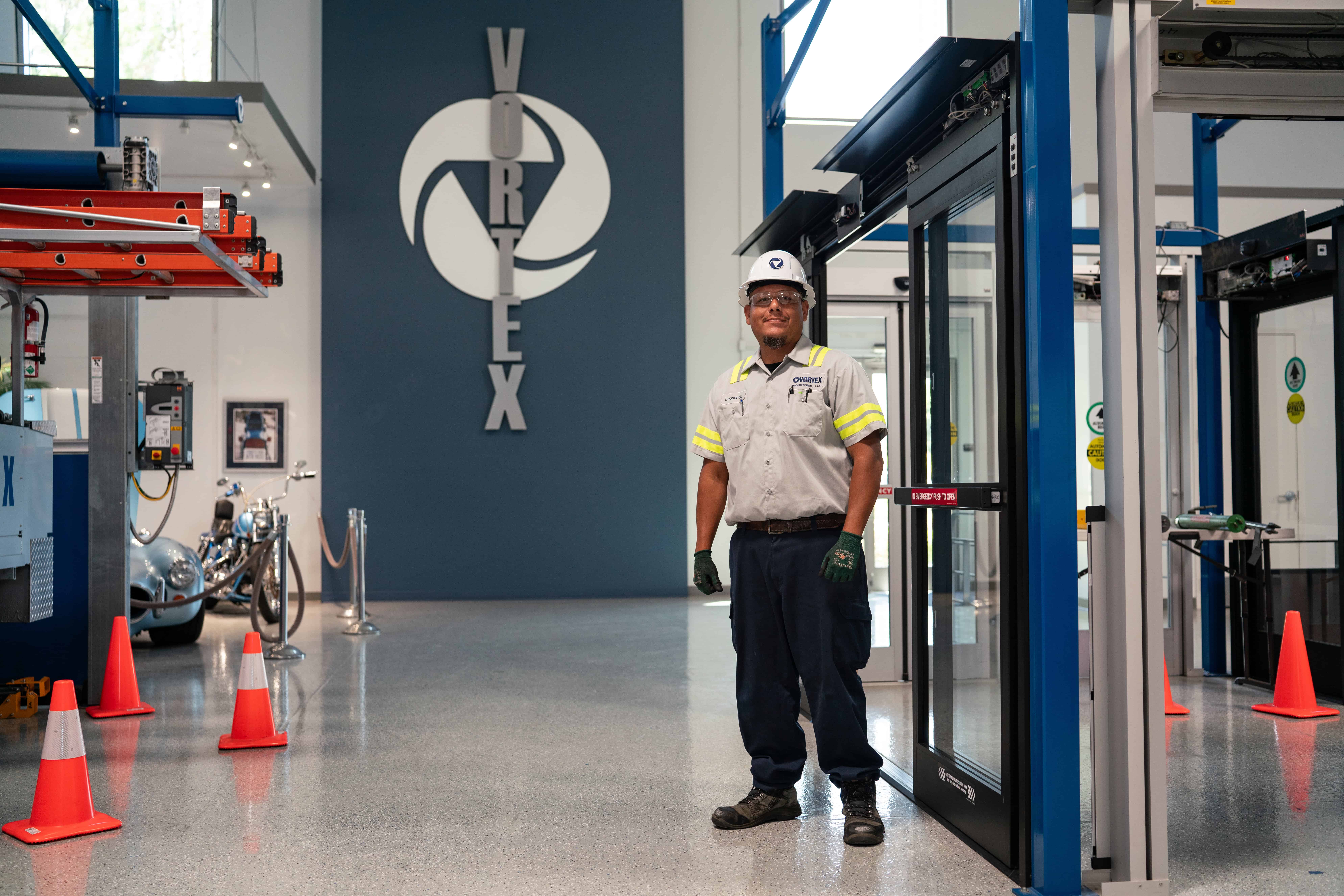 A Vortex service technician standing in front of an automatic door at one of our training centers