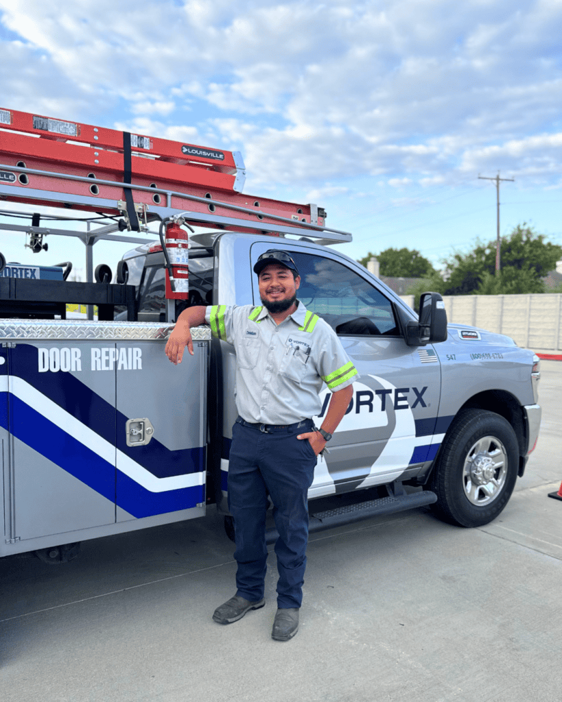 Smiling Vortex Technician in front of a Vortex Truck