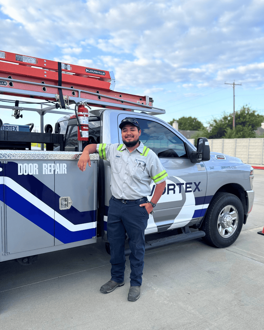 Smiling Vortex Technician in front of a Vortex Truck